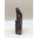 A hand carved oriental soapstone figure seal/ paperweight. Measures 13.5cm in height.