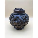 A Chinese hand carved tobacco pot and lid. Measures 17cm in height.