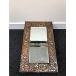 An arts and crafts copper framed, bevel edge mirror.