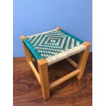 A small weaved top foot stool