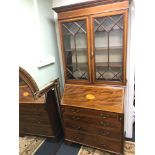 A Georgian bureau bookcase, with Shell design inlay. Measures 211x100x48cm