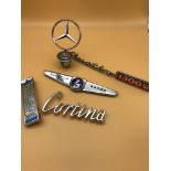 A Lot of vintage car badges and mascots, Includes Mercedes Benz, Cortina, Austin & Sunbeam.