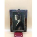 An Antique wooden wall plaque, poker work edging and depicting a side profile of a lady figure.