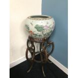 An Oriental ornate planter with hardwood stand. Measures 80cm in height