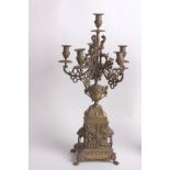 A pair of French gilt metal six light candelabra, circa 1800, the sockets and drip pans on foliate