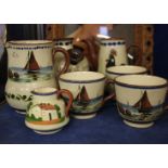 Torquay Ware a group of cups, jugs, vases, a pair of bowling balls W Lindop, Manchester, a cannon,
