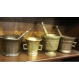A collection of four bell metal and brass mortars and three pestles most 19th century