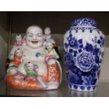 A Delft Chinese design ginger jar with cover and a porcelain Buddha with children group