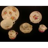 A Coalport cup and saucer, a Continental chocolate cup with cover, and another, a Meissen flower