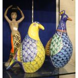 Two large pottery birds, colourfully decorated, height approximately 37cm and a ceramic figure: