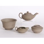 A Wedgwood caneware miniature three piece tea set and a flared bowl. Impressed mark, tea pot w: 14.