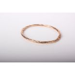 A modern 9ct rose gold hollow rope-twist hinged bangle, post 2000 Sheffield convention hallmarks,