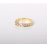 A modern 18ct gold and diamond seven stone half-eternity ring, the round brilliants approx. 0.