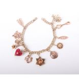 A modern Italian gold double curb 'charm' bracelet, hung with 11 Cloggau Welsh gold charms, some gem