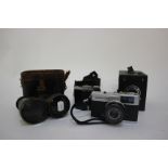 Three cameras: a Warwick No. 2, Baby Brownie and Olympus Trip 35 and a pair of binoculars in part