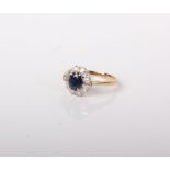 An 18ct gold, sapphire and diamond oval cluster ring, centred with an oval mixed-cut sapphire within