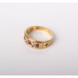 An early 20th century gold, ruby and diamond five stone gypsy ring, stamped ‘18’, maker’s mark ‘C.