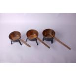 A group of three skillets two named T Ale Sons and T P B Water III