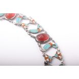 An Egyptianesque white metal, enamel and carnelian bracelet, with form or four oval carnelian