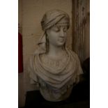 A 19th century weathered marble bust of a young lady wearing a tasselled head scarf, unsigned height