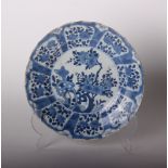 A Chinese blue and white dish, Kangxi, the centre painted with flowers issuing from pierced