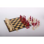 An ivory and bone Barlycorn chess set (red and white), King height 10.5cm, with associated box and