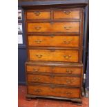 A George III stained oak chest on chest of two short and six long drawers with mahogany crossbanding