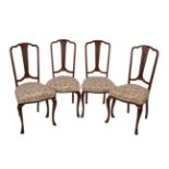 A set of six dining chairs, circa 1930, each with paterae and bell flowers to the vertical splat