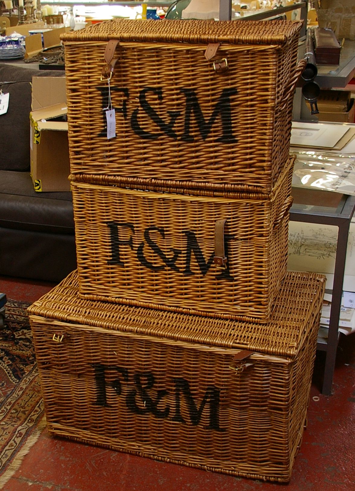 Three Fortnum & Masons cane work hampers (two 57cm, one 76cm) all stencilled 'F&M' to front