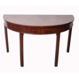 A 19th century mahogany semi elliptical side table with reeded legs, Sotheby label, w.121cm d.62cm