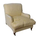 A pair of Howard armchairs, classic splay seats with roll arms and turned front legs, back legs