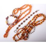 Two modern Baltic amber baroque-shaped bead necklaces; two similar amber bead 'elasticated'