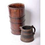 A coopered cylindrical stick stand, probably 19th century (h.64cm) and a large coopered jug with