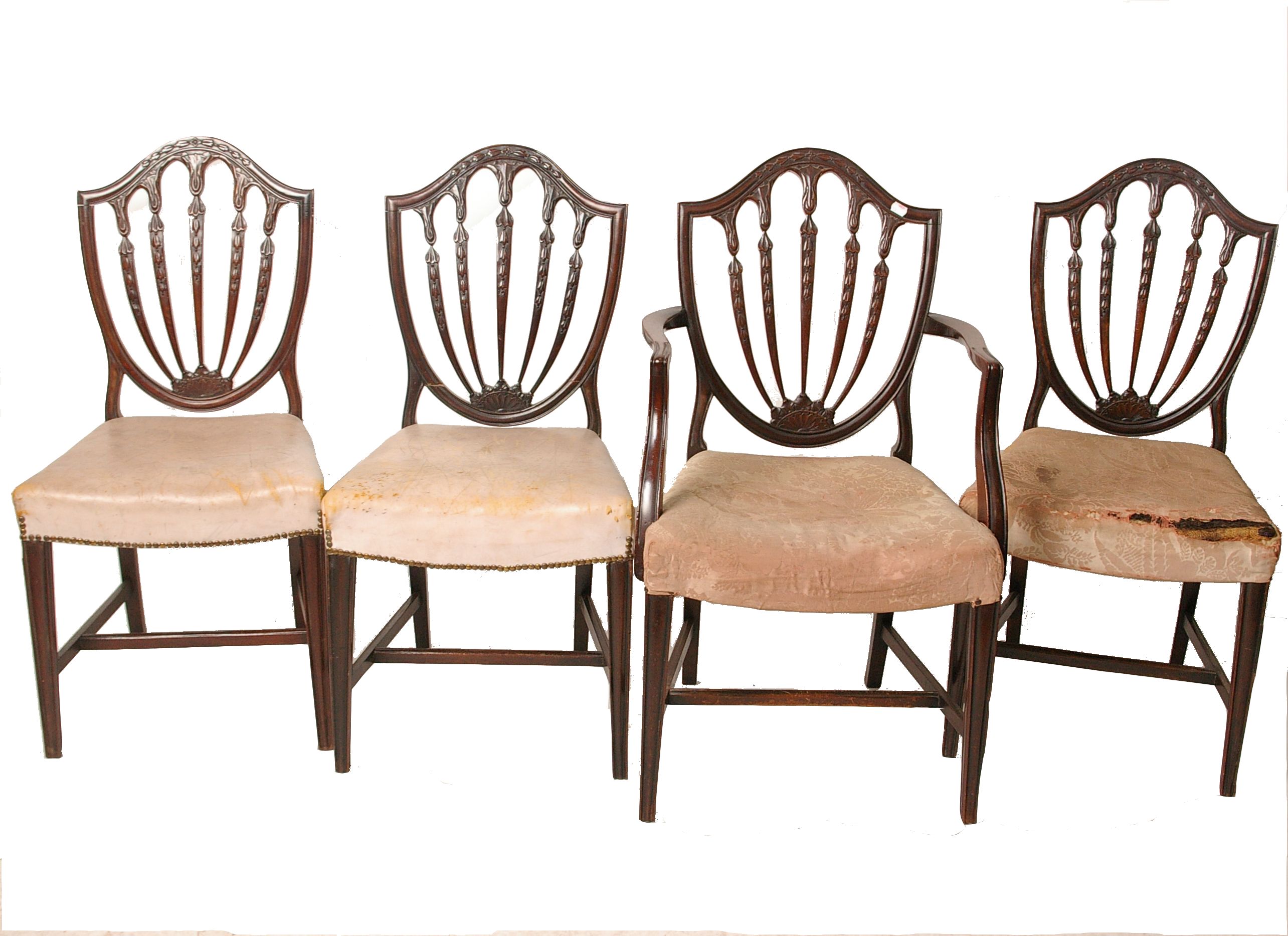 A set of four George III mahogany dining chairs, to include one armchair