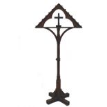 An ecclesiastic tall candle stand with fourteen brass holders to the arch top and turned stand, poor