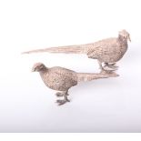 A pair of modern silver small models of a pair of pheasants, marks indistinct, the cock bird