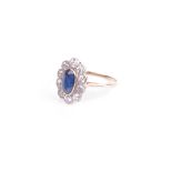 An early 20th century gold, sapphire and diamond oval cluster ring, centred with an oval mixed-cut