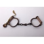 Locks: a pair of handcuffs with screw key, probably early 20th century