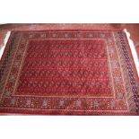 A modern red ground Bokhara carpet 230 x 160cm