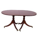 A Regency style mahogany twin pedestal dining table with an additional leaf 73cm high, 208cm