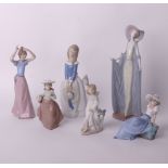 A Lladro figurine: tall cloaked lady (no.1428) and five Nao figurines of young girls (6)