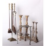 A 19th century brass and iron kettle stand, fire iron set on stand and four wooden candle sticks