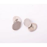 A pair of silver oval engine-turned & plain oval twin-panel cufflinks with chain inter-links,