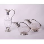 Three glass decanters Etains du Manoir, Paris, two modelled as stylised birds, all with pewter