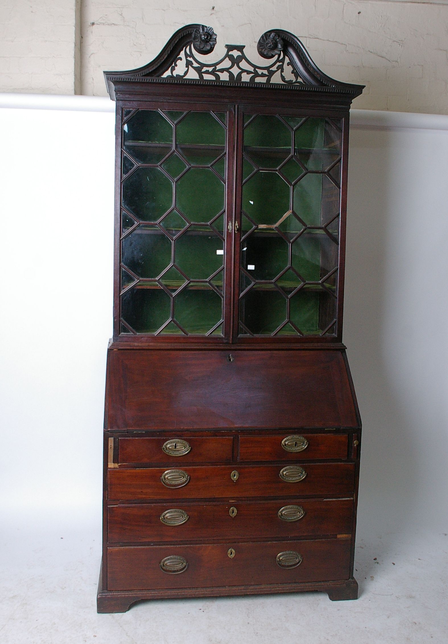 A George III mahogany bureau, the fall enclosing a fitted interior with pigeonholes and drawers,