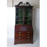 A George III mahogany bureau, the fall enclosing a fitted interior with pigeonholes and drawers,