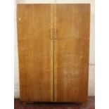 A mid 20th century oak wardrobe, chest of drawers and dressing table