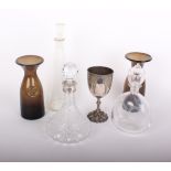 A cut glass decanter with silver collar, a silver plated Victorian goblet three decanters, two