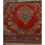 A Mahal carpet, the salmon pink ground with a central medallion surrounded by scrolling leaves and