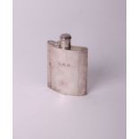 A silver concave hip flask with a hinged screw cover & engraved on the side with initials ‘J.W.K’